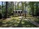 Charming home nestled in a wooded lot with a brick pathway leading to the front entrance at 133 Otter Run Rd., Pawleys Island, SC 29585