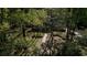 Aerial view of a charming home with a landscaped front yard and a winding brick walkway through the trees at 133 Otter Run Rd., Pawleys Island, SC 29585