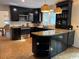Modern kitchen with black cabinets, stainless steel appliances, and countertops with breakfast bar at 133 Otter Run Rd., Pawleys Island, SC 29585