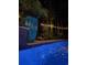 Relaxing poolside view with string lights, tropical plants, and refreshing, cool water at 133 Otter Run Rd., Pawleys Island, SC 29585