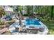 Backyard oasis featuring a large in-ground pool, patio, and lush greenery at 133 Otter Run Rd., Pawleys Island, SC 29585