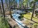 Drone shot of a quaint renovated home on a verdant lot surrounded by mature trees and partial fencing at 746 Gumbo Limbo Ln., Myrtle Beach, SC 29579