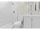 The clean, white bathroom features a marble tiled shower and modern vanity at 746 Gumbo Limbo Ln., Myrtle Beach, SC 29579