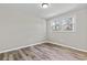 A bright bedroom with a window and wood-look floors offers a cozy and inviting space at 746 Gumbo Limbo Ln., Myrtle Beach, SC 29579
