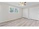 The vacant bedroom boasts wood-look floors, a window, and double closets for ample storage at 746 Gumbo Limbo Ln., Myrtle Beach, SC 29579