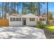 Charming, renovated single-story home with a white brick facade, new driveway, and manicured landscaping at 746 Gumbo Limbo Ln., Myrtle Beach, SC 29579