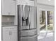 Modern kitchen featuring a large stainless steel refrigerator and bright white cabinets at 746 Gumbo Limbo Ln., Myrtle Beach, SC 29579