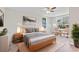 Staged main bedroom with wood-look floors, natural light, and calming decor at 746 Gumbo Limbo Ln., Myrtle Beach, SC 29579