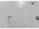 New bathroom shower featuring elegant marble tile, shower head, and convenient built-in shelving at 746 Gumbo Limbo Ln., Myrtle Beach, SC 29579