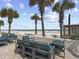 Charming patio area overlooking the beach with comfortable seating and swaying palm trees at 1 Norris Dr. # 249, Pawleys Island, SC 29585