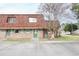 Cozy brick townhouse featuring a charming red roof, green door, and windows at 1025 Carolina Rd. # O4, Conway, SC 29526