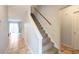 Carpeted stairs with a wooden handrail leads to the upper level at 1025 Carolina Rd. # O4, Conway, SC 29526