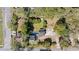 An aerial view of a home showcasing its lot, driveway, mature trees, and surrounding neighborhood at 103 N Magnolia Ave., Andrews, SC 29510