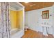 Cozy bathroom featuring a shower-tub combo, pedestal sink, and bright lighting at 103 N Magnolia Ave., Andrews, SC 29510