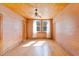 Large bedroom with hardwood floors, natural light from windows, and a ceiling fan at 103 N Magnolia Ave., Andrews, SC 29510