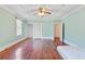 Large bedroom with hardwood floors, closet space, and a bright window, perfect for relaxation at 103 N Magnolia Ave., Andrews, SC 29510