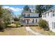 Charming two-story home with a covered front porch and classic architectural details, surrounded by greenery at 103 N Magnolia Ave., Andrews, SC 29510