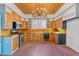 Kitchen with custom wood cabinets, brick flooring, and stainless appliances at 103 N Magnolia Ave., Andrews, SC 29510