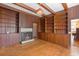 Living room with wood paneling, a fireplace, and built-in shelves at 103 N Magnolia Ave., Andrews, SC 29510