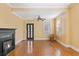 Bright living room with hardwood floors, fireplace, and ceiling fan at 103 N Magnolia Ave., Andrews, SC 29510