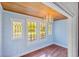 Charming living room with decorative windows, hardwood floors, and a stylish chandelier at 103 N Magnolia Ave., Andrews, SC 29510