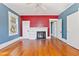 Inviting living room features hardwood floors, large windows, and a decorative fireplace at 103 N Magnolia Ave., Andrews, SC 29510