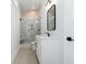 Modern bathroom with sleek vanity, contemporary lighting, and glass-enclosed shower with tile surround at 105 Serenity Point Dr., Little River, SC 29566