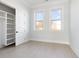 Light-filled bedroom with built-in closet, large windows, and hardwood flooring, offering comfortable living at 105 Serenity Point Dr., Little River, SC 29566