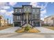 Stunning three-story home featuring a stylish facade, dual garages, and an inviting landscaped entrance at 105 Serenity Point Dr., Little River, SC 29566