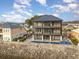Striking three-story waterfront home with balconies overlooking a pool and waterfront at 105 Serenity Point Dr., Little River, SC 29566