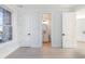 A hallway leading into the bathroom features modern paneled doors and lots of natural light at 105 Serenity Point Dr., Little River, SC 29566