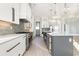 Bright kitchen with stainless steel appliances, a large island, stylish pendant lighting, and custom cabinetry at 105 Serenity Point Dr., Little River, SC 29566