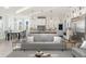 Open-concept living space with a modern kitchen, breakfast bar, and elegant dining area with abundant natural light at 105 Serenity Point Dr., Little River, SC 29566