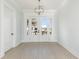 An elegant living room is filled with light from large French doors that offer a view of the neighborhood at 105 Serenity Point Dr., Little River, SC 29566