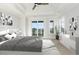 Serene main bedroom with balcony access, tray ceilings, and abundant natural light at 105 Serenity Point Dr., Little River, SC 29566