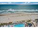 Stunning aerial shot of oceanfront property with pool, beach access, and lush landscaping at 107 S Ocean Blvd. # 1407, Myrtle Beach, SC 29577