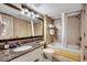 Well-lit bathroom with granite countertop, modern fixtures, and a shower-tub combo for relaxation at 107 S Ocean Blvd. # 1407, Myrtle Beach, SC 29577