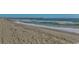 Scenic beach view with a pier in the distance and gentle waves rolling in, offering a serene coastal atmosphere at 107 S Ocean Blvd. # 1407, Myrtle Beach, SC 29577