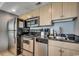 Efficient kitchen featuring stainless steel appliances, granite counters, and ample cabinet space at 107 S Ocean Blvd. # 1407, Myrtle Beach, SC 29577