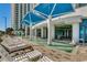 Inviting pool area with shaded seating and lounge chairs, perfect for relaxation and socializing at 107 S Ocean Blvd. # 1407, Myrtle Beach, SC 29577