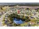 Aerial view of a charming neighborhood with a community pond, surrounded by lush greenery and well-maintained homes at 1113 Green Fir Loop, Conway, SC 29527