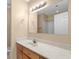 Well-lit bathroom featuring a wood vanity with long countertop, large mirror, and tub at 1113 Green Fir Loop, Conway, SC 29527