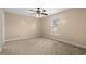 Bright bedroom featuring neutral walls, carpeted floor, ceiling fan, and a sunlit window at 1113 Green Fir Loop, Conway, SC 29527