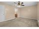 Bedroom with neutral walls, carpet, ceiling fan, and an open door to the attached bathroom at 1113 Green Fir Loop, Conway, SC 29527