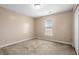Bright bedroom features neutral walls, carpet flooring, and a window that lets in natural light at 1113 Green Fir Loop, Conway, SC 29527