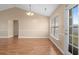 Well-lit dining area offers hardwood floors, a stylish light fixture, and backyard access at 1113 Green Fir Loop, Conway, SC 29527