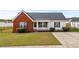 Charming one-story home featuring brick facade and well-manicured lawn in a Gathering-friendly neighborhood at 1113 Green Fir Loop, Conway, SC 29527