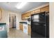 Efficient kitchen with ample cabinet space, black appliances, and easy access to laundry area at 1113 Green Fir Loop, Conway, SC 29527