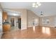 Open-concept living room featuring hardwood floors, adjacent to the kitchen for modern living at 1113 Green Fir Loop, Conway, SC 29527