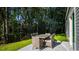 Outdoor patio area with dining table, seating, and backyard at 1151 Silver Perch Place, Sunset Beach, NC 28468